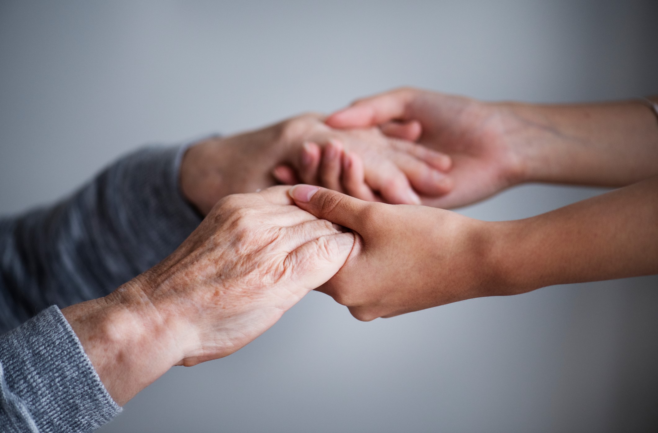 Manos entrelazadas simbolizando confianza en el tratamiento psicológico del Parkinson